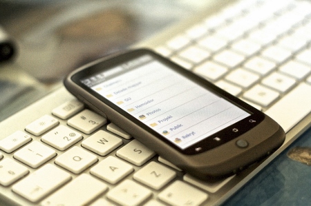 Image of a cell phone and keyboard to symbolize potential telecommunications products.