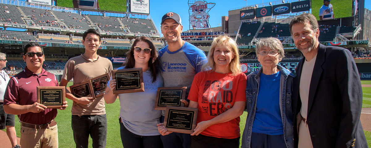 Members of PeaceMaker partner schools experiencing who demonstrated the sharpest decline in bullying rates are honored at a Twings game